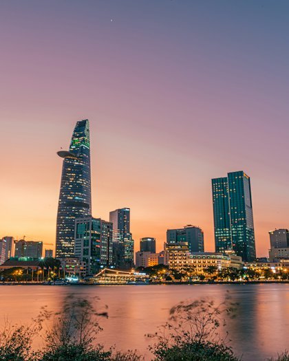 Singapore high-rise skyline glowing at dusk across the water