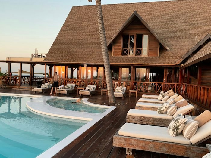 Sun loungers beside a quiet resort swimming pool