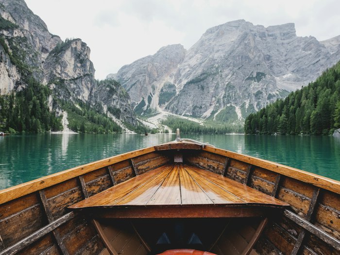 Turquoise lake water below steep alpine cliffs