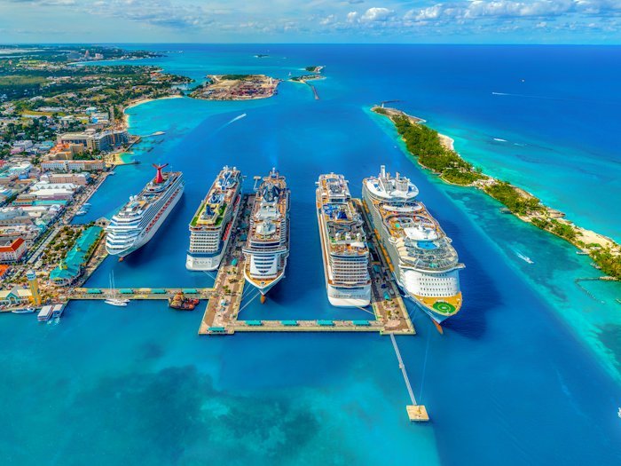 Cruise ships lined up alongside a tropical port