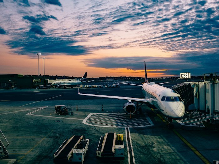 An aircraft waiting at the boarding gate during golden hour