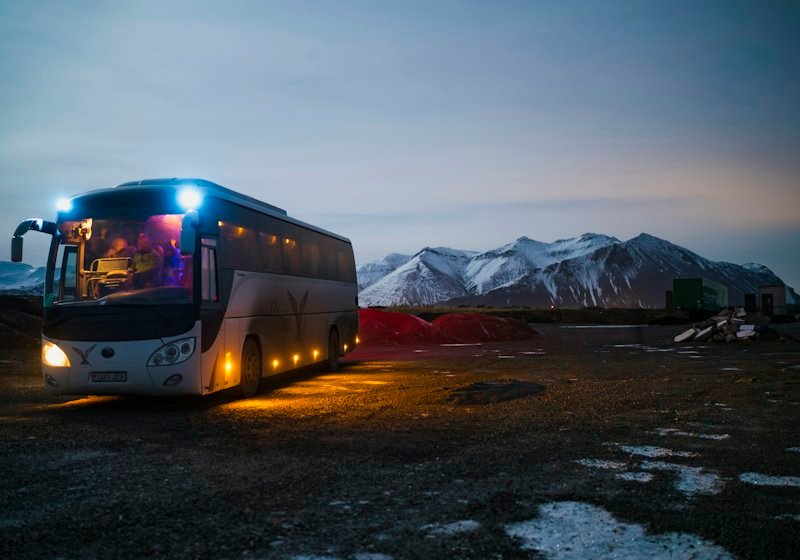 A long-distance coach on a mountain road at night