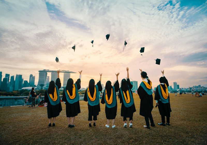 Graduating students throwing their caps into the air