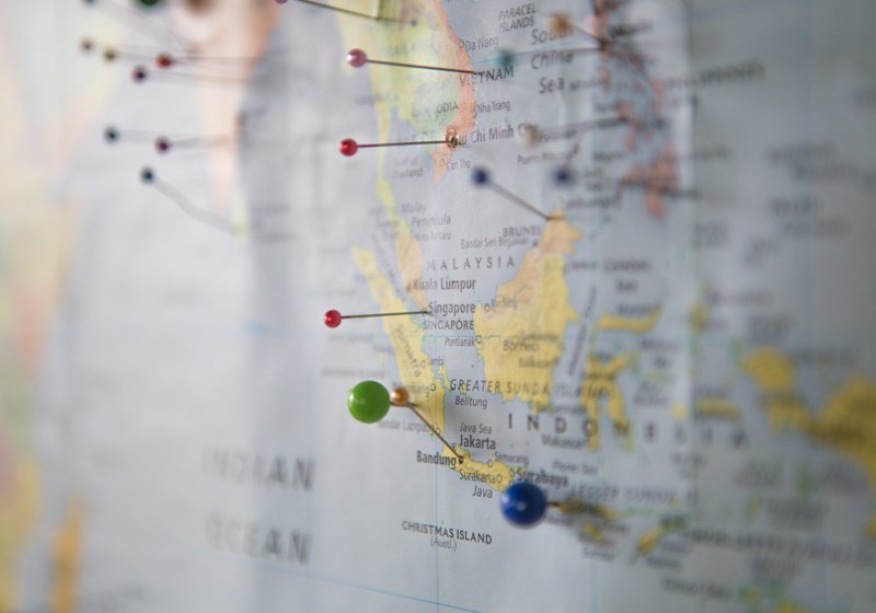 A world map marked with coloured pins